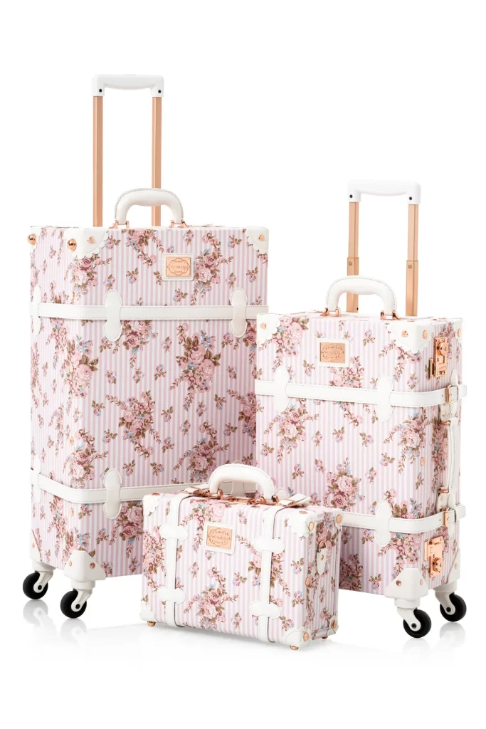 Three floral-printed luggage pieces in different sizes, neatly arranged side by side.