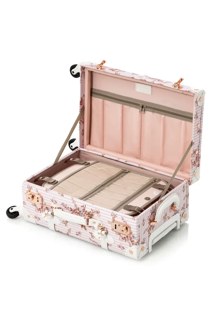 An open luggage, featuring a stylish pink suitcase adorned with floral pattern. 