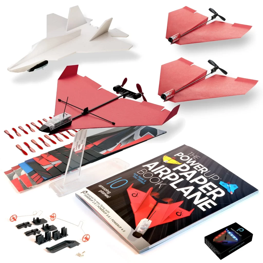 An image of POWERUP's Family Squadron Bundle, featuring a model airplane, a book, and various accessories.