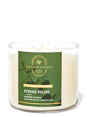 A scented candle in a glass jar with a label that reads "Bath & Body Works Eucalyptus Spearmint 3-Wick Candle."