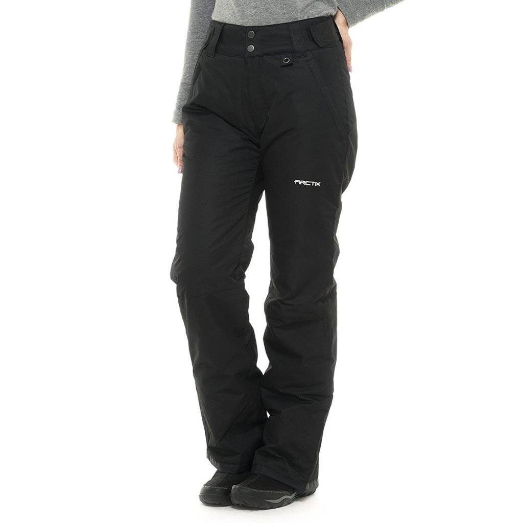 A woman in black snow pants and a grey long-sleeved shirt, ready for some winter fun!