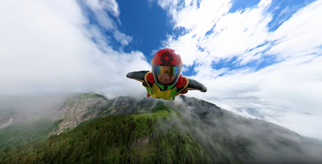 Skydiving adventure! This image shows a person gracefully gliding through the air on a parachute, captured by the Insta360 X3 action camera.