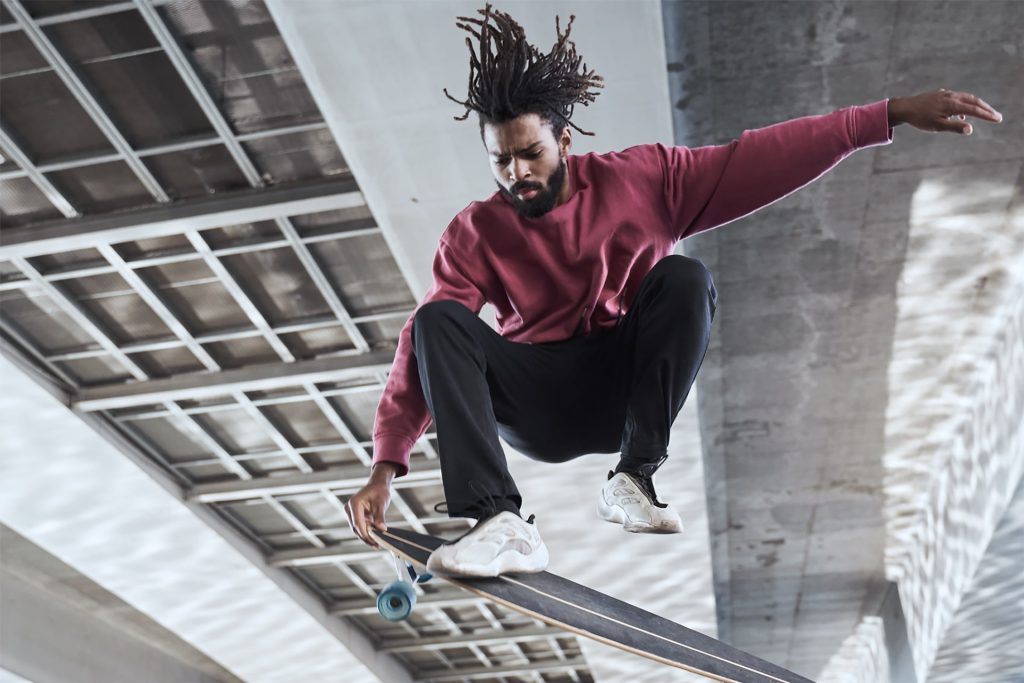 A dude with dreadlocks nailing a skateboard trick. Shot by Akaso Brave 7 LE, a budget-friendly action camera for epic outdoor adventures.