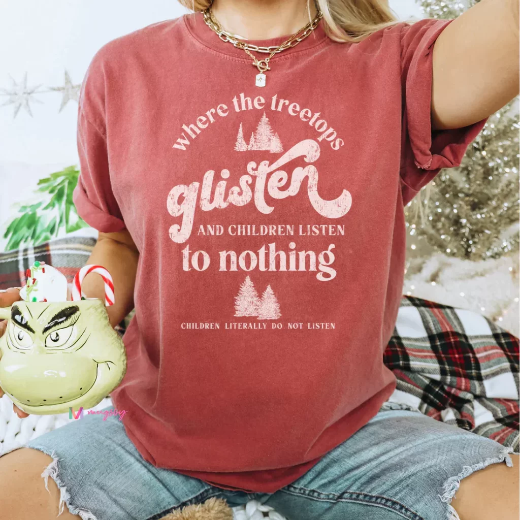 A festive Christmas t-shirt with glittery trees and sparkling lights in the background. Perfect for spreading holiday cheer!