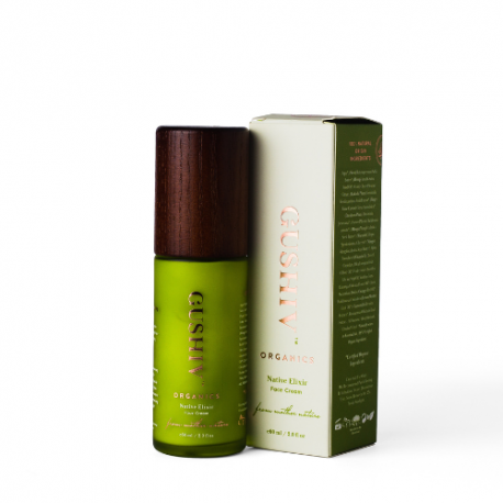 A Gushiv Organic face cream with a green body, wood-like cap, and whitish-green packaging, showcased against a white background.