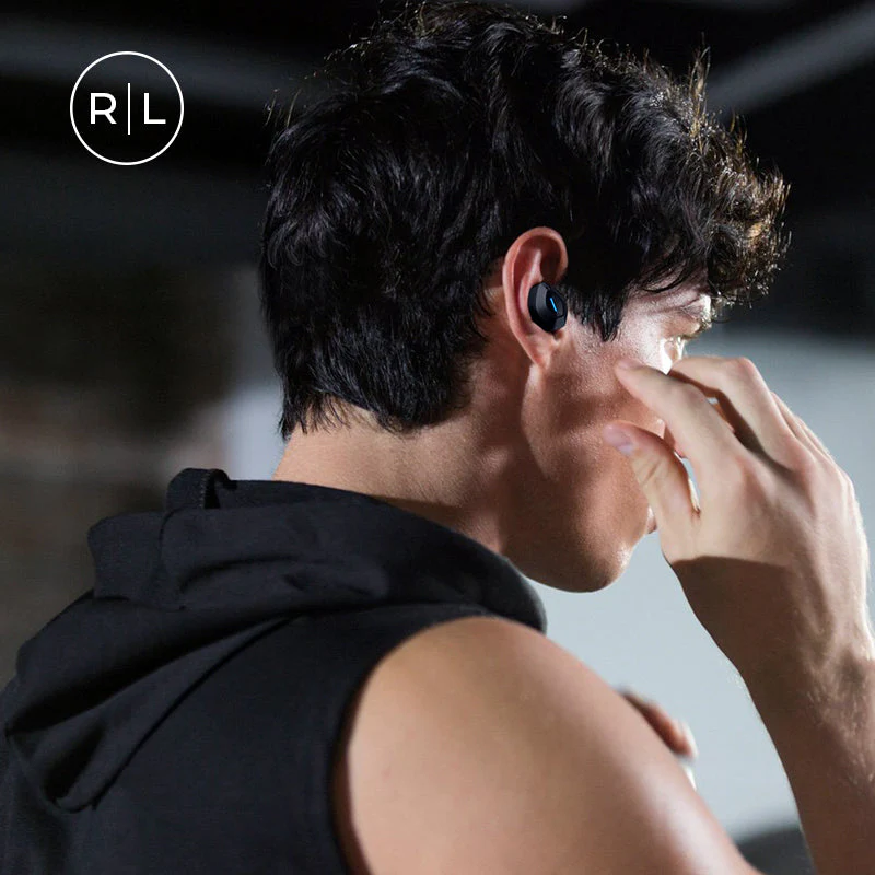 A man wearing a short-sleeved black hoodie is sporting a pair of COWIN APEX Active Noise Cancelling Wireless Earbuds.