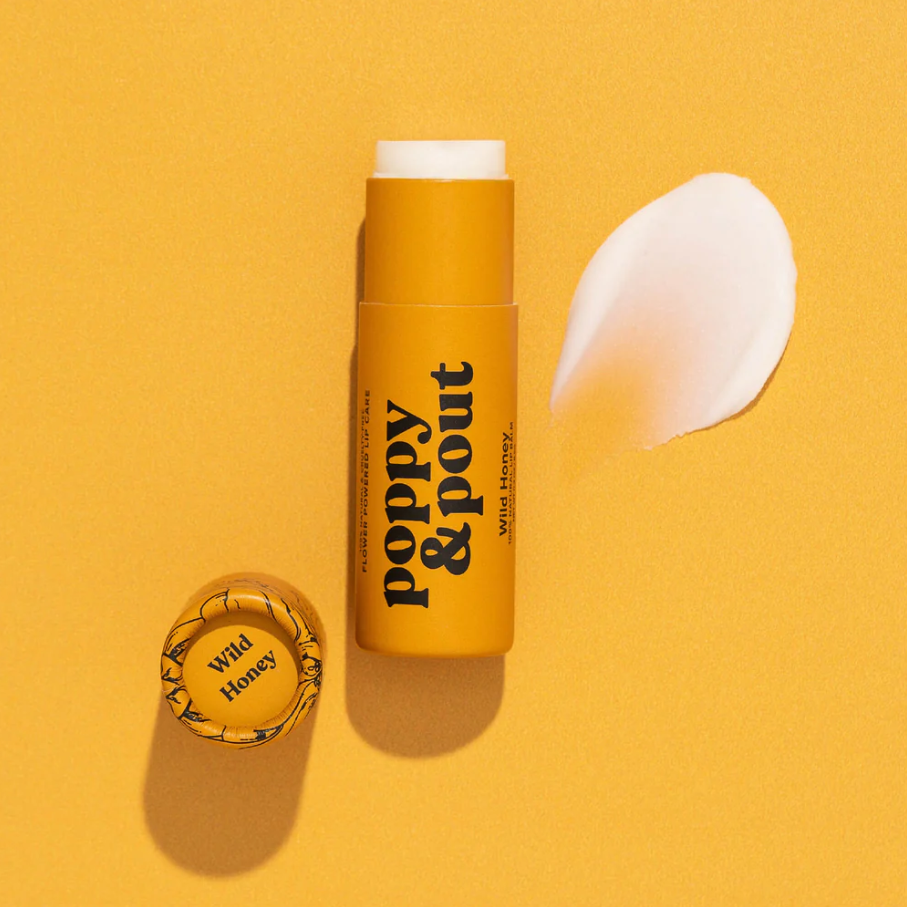 Poppy & Pout Lip Balm with natural beeswax, organic coconut oil, and essential oils, providing hydration and a subtle sweet honey scent for daily lip care.